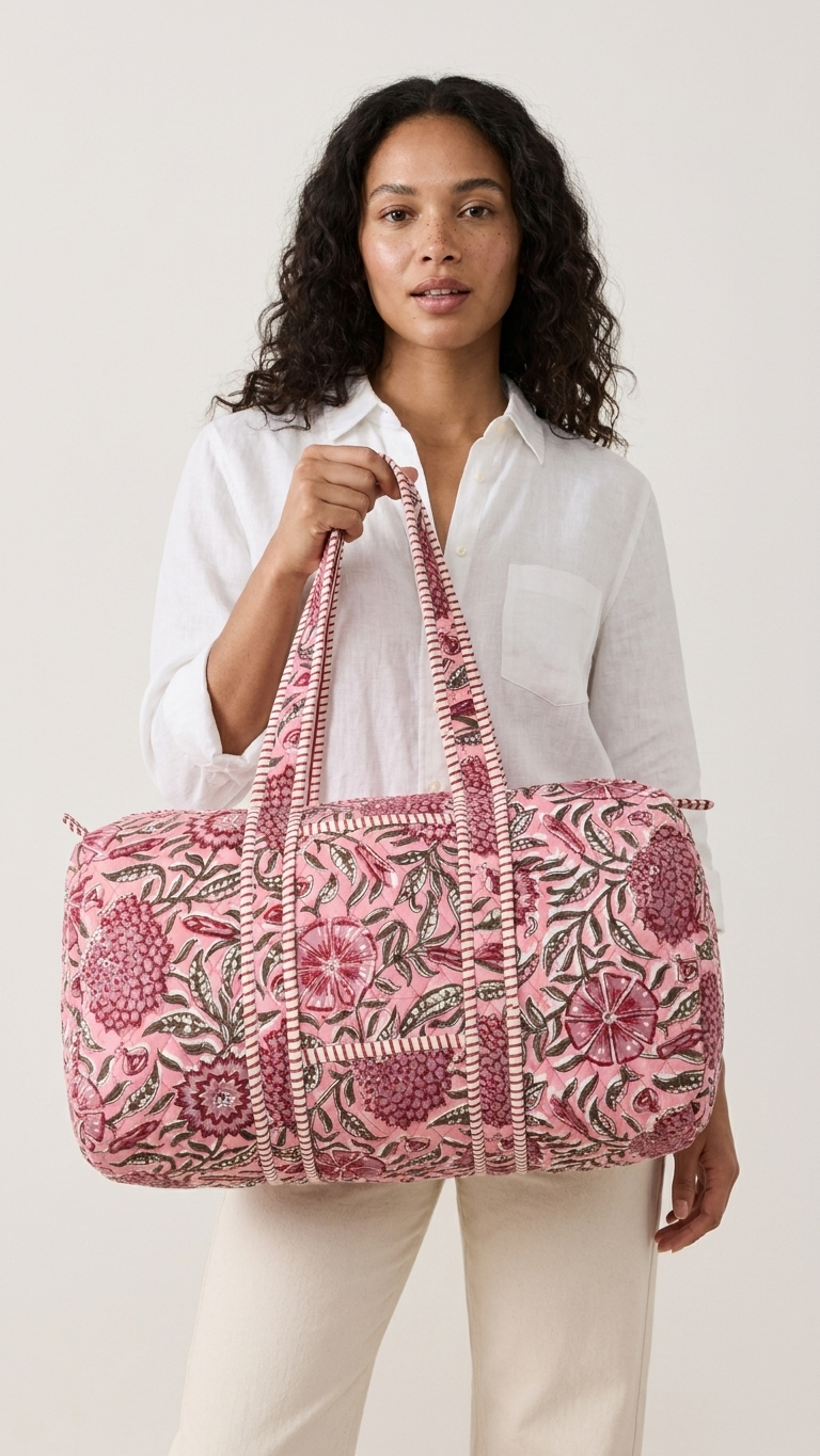 DUFFLE BAG  - Pink floral pattern with red and green accents.