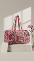 DUFFLE BAG  - Pink floral pattern with red and green accents.